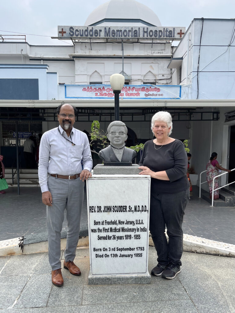 Medical Director Dr. Suresh and me at the Dr. John statue in the hospital's memorial garden.
